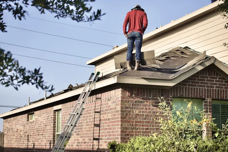 Professional roofer working on a residential roof in Lakefront